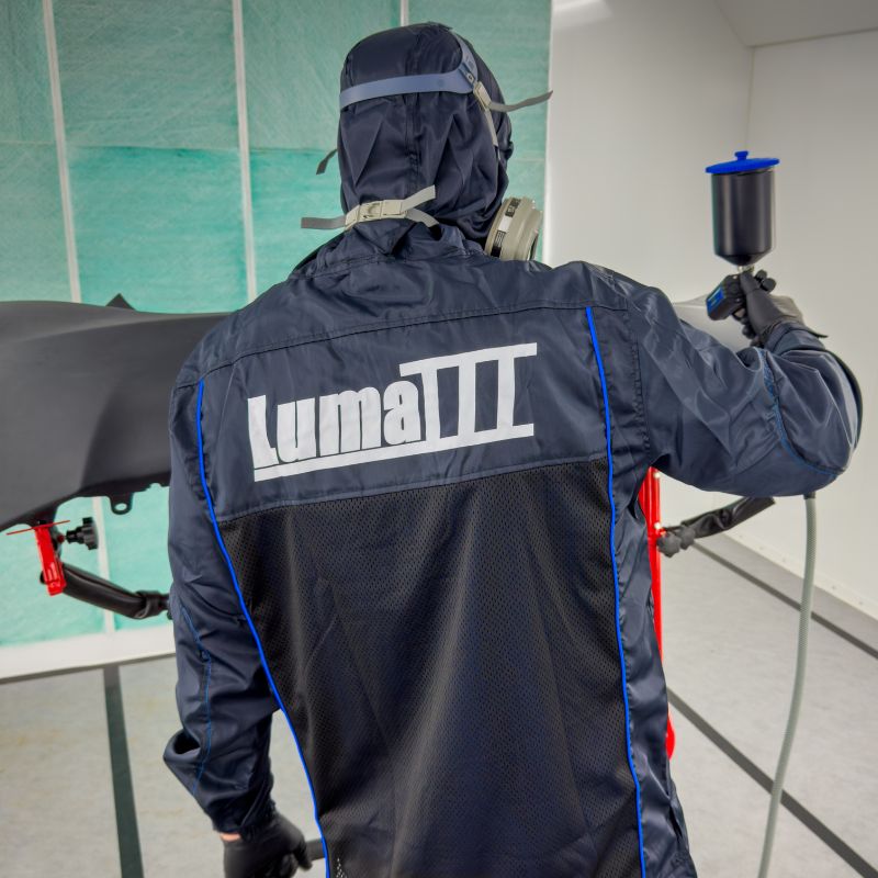Person in a spray booth wearing Luma III Lab Coat.